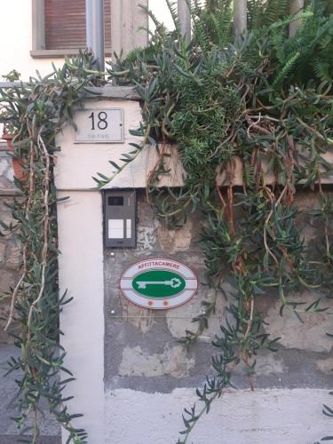a white door with plants on the side of a building at Bressa de Ma affittacamere, room & breakfast in Pietra Ligure