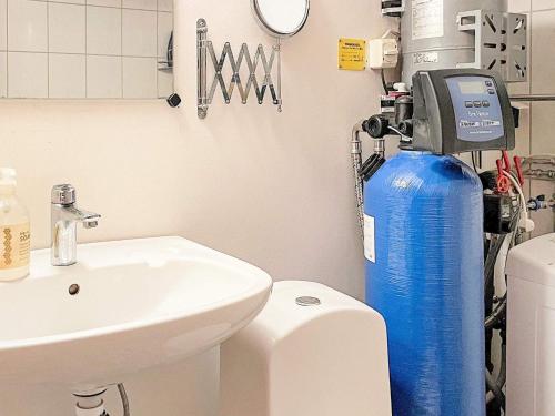 a bathroom with a blue water tank next to a sink at Holiday home SEXDREGA in Sexdrega