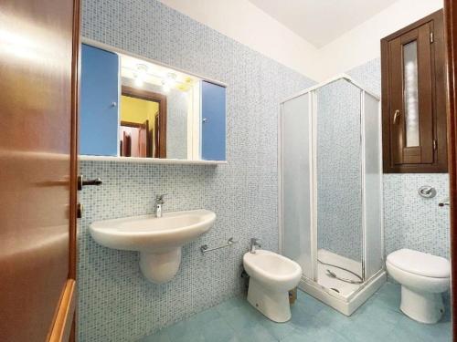 a bathroom with a sink and a toilet at Casa Serena in San Vito lo Capo