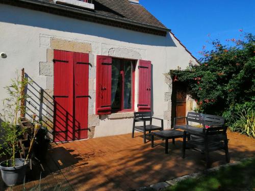 a house with red shuttered windows and a bench at Paradise Grand Jardin et Terrasse 2 chambres in Férolles