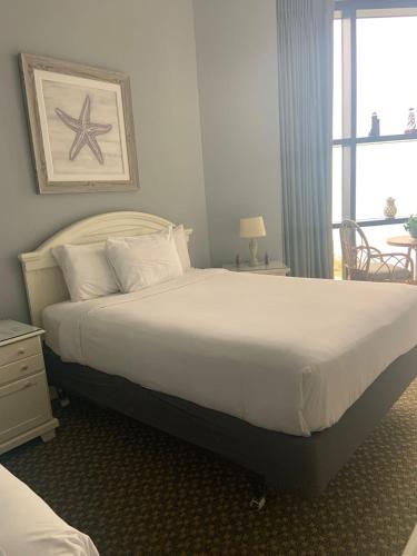 a bedroom with a large bed and a window at 2Br Penthouse in the Ocean Forest Plaza in Myrtle Beach