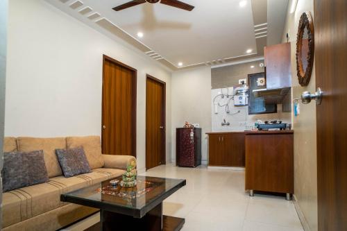 a living room with a couch and a table at The Lodgers 2 BHK Serviced Apartment infront of Artemis Hospital Gurgaon in Gurgaon
