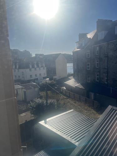a view of a city with the sun in the sky at Dunarle Guesthouse in Oban