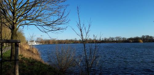a large lake with a boat in the distance at Maison Rose in Ypres