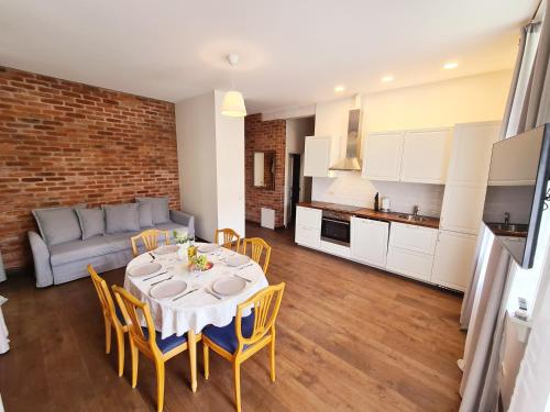 a kitchen and living room with a table and chairs at Villa Loebel - Exceptional two bedroom apartment with balcony and verandah in Juodkrantė