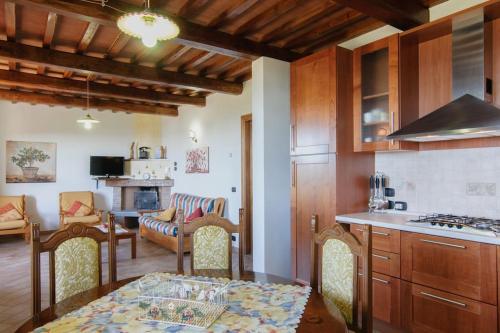 a kitchen and living room with a table and a stove at Villa Perugini in Tuoro sul Trasimeno