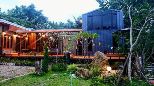a house with a blue building on a bridge at Heaven Hill Camping in Ban Thung Na