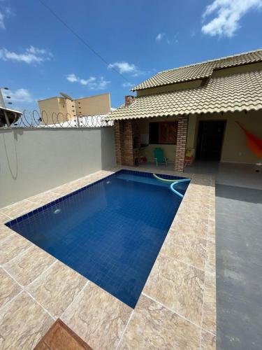 a swimming pool in the backyard of a house at Casa de Praia do Luiz in Luis Correia