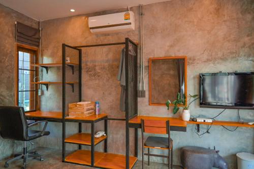 a room with two desks and a mirror and a tv at Heaven Hill Camping in Ban Thung Na