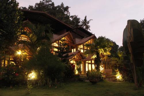 a large building with lights in front of it at Avalon Ubud Castle & SPA in Ubud