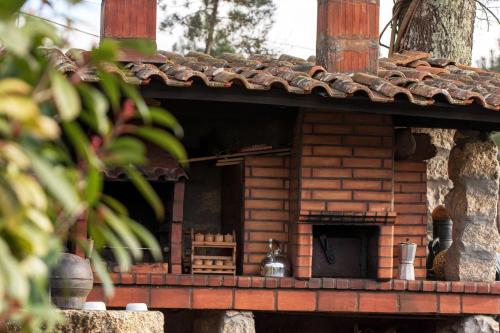 a brick building with a fireplace in the middle at Casa Senhor da Ponte in Mondim de Basto