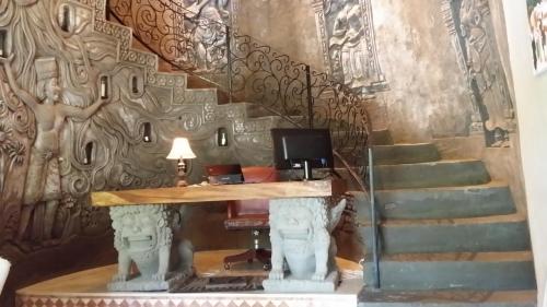 a set of stairs with a desk in a room at Avalon Ubud Castle & SPA in Ubud