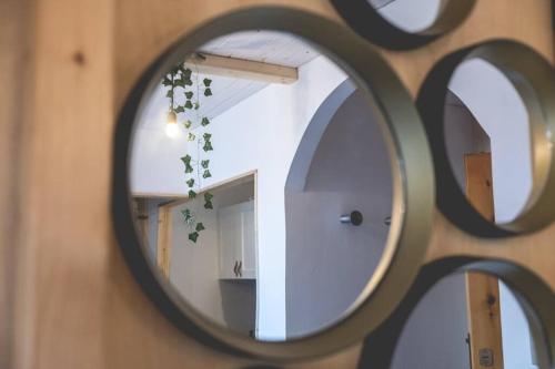a mirror hanging on a wall with a room at La casa sul Monviso in Montoso
