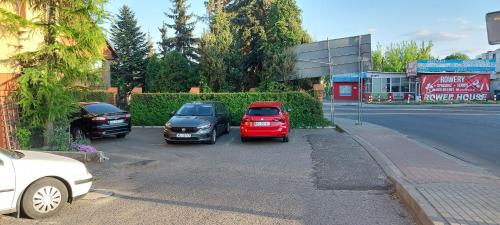 a group of cars parked on the side of a street at Zajazd Błonie in Błonie