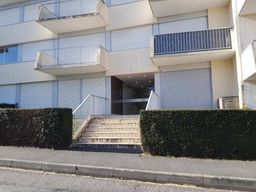 a building with stairs in front of a building at Le studio 19 in Saint-Cast-le-Guildo