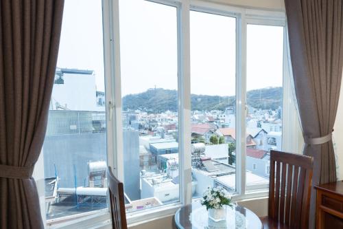 a large window with a view of a city at Queen Garden Hotel & Apartment in Vung Tau
