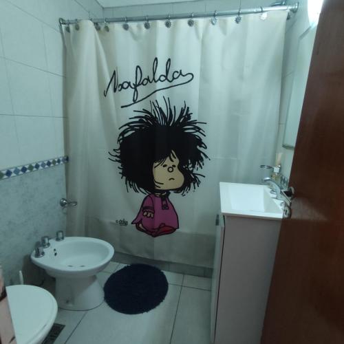 a bathroom with a shower curtain with a girl on it at LUAMAR in Mar del Plata