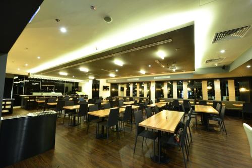 a restaurant with wooden tables and chairs in it at The Seacare Hotel in Singapore