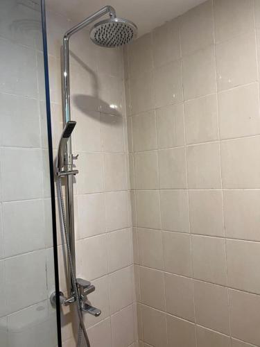 a shower with a glass door in a bathroom at Ayla City Hotel in Sorong