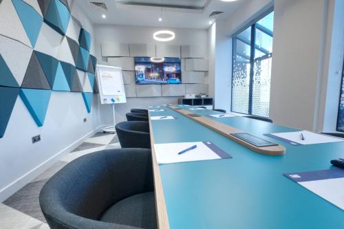 a conference room with blue tables and chairs at Holiday Inn Express - Fleet by IHG in Fleet