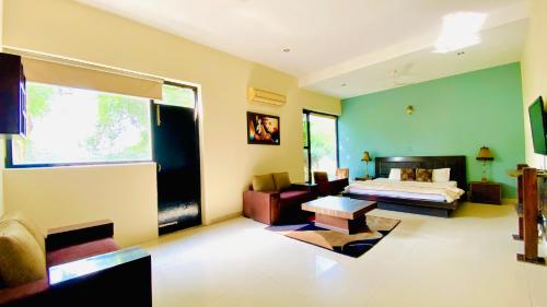 a large room with a bed and a couch at Spring Gardens and Farmstay in Amritsar