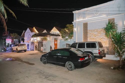 a black car parked next to a house at night at Lavender Tan Thanh Hotel mini resort in Cong Thanh (3)