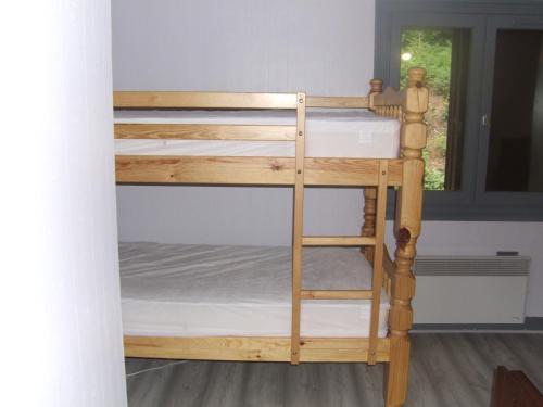 a set of bunk beds in a room with a window at gite bertry 