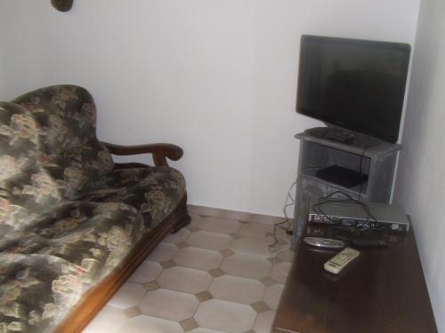 a living room with a couch and a flat screen tv at gite bertry 
