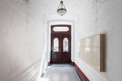 a hallway with a wooden door in a building at Astronomical Clock Apartment in Prague