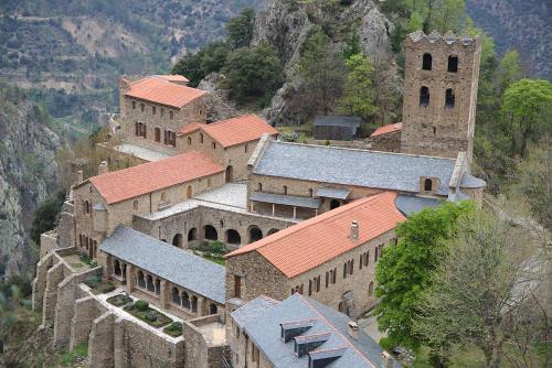 a group of buildings with red roofs on a mountain at Les loges de la suite in Prades