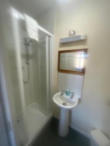 a bathroom with a sink and a shower at DunMoore Guesthouse in Oban