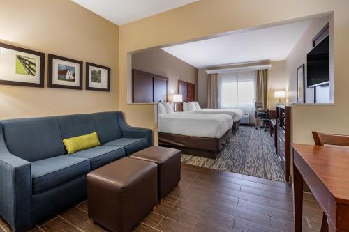 a hotel room with a bed and a couch at Comfort Suites Keeneland in Lexington