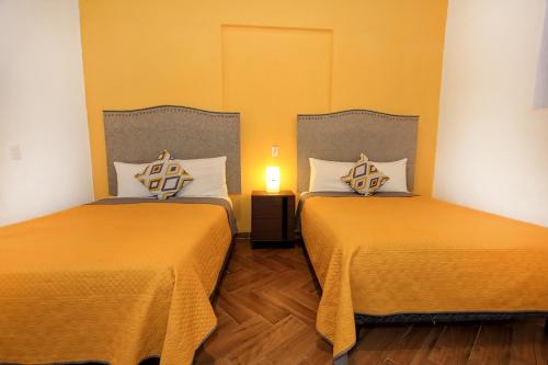 Postel nebo postele na pokoji v ubytování Hotel Universidad