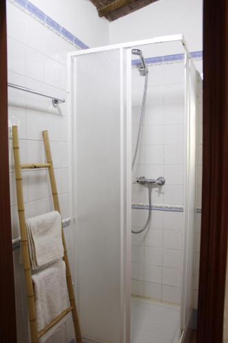 a shower with a glass door in a bathroom at Casa Refúgio in Évora