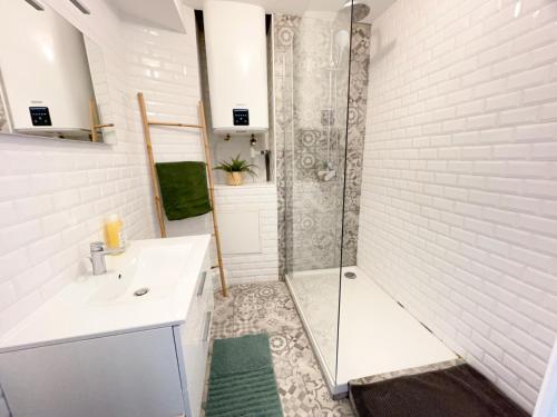baño blanco con ducha y lavamanos en Superbe appartement, 3 chambres, gare St Charles, en Marsella
