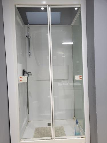 a shower with a glass door in a bathroom at STUDIO DONDAINES in Lille