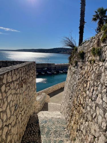 a stone wall with stairs leading to a beach at Itaca in Castro di Lecce