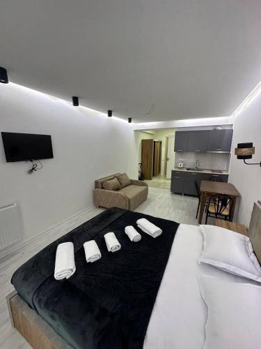 a bedroom with a large bed with three white pillows at New Gudauri, Hotel Peak in Gudauri