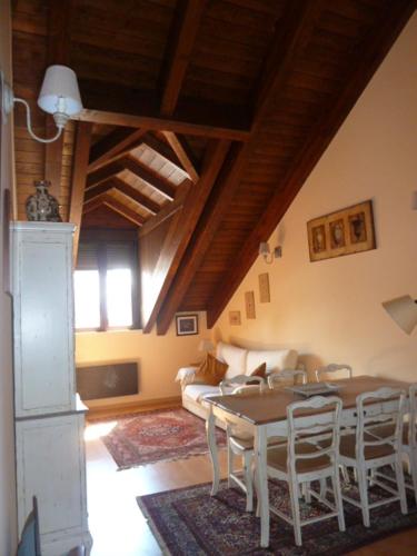a living room with a table and chairs and a couch at La buhardilla de Mayte in Broto