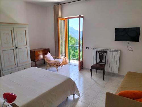 a bedroom with a bed and a fireplace and a television at La Casa in Vigna in Tramonti