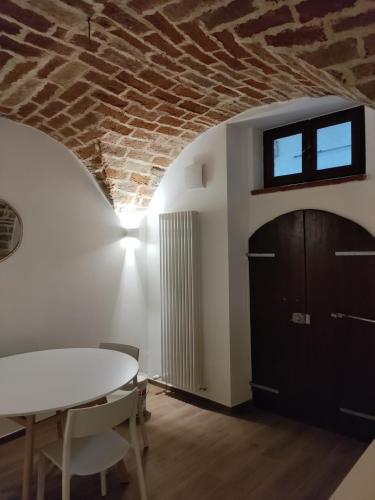 a dining room with a table and a brick wall at CASA GAH in Ripatransone