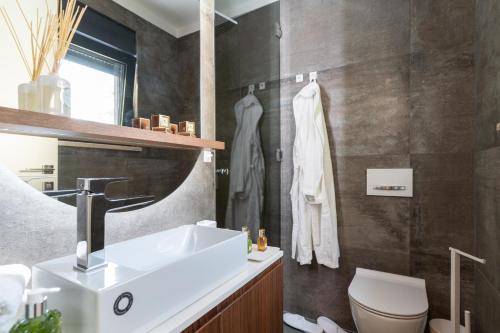 a bathroom with a sink and a toilet at EZ Luxury Living in Rovinj