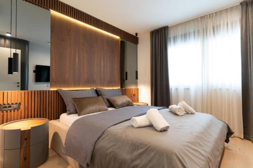 a bedroom with a large bed with two towels on it at EZ Luxury Living in Rovinj