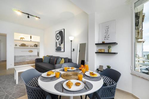 a dining room with a table with plates of food on it at WHome Peaceful Algés Family Home away from City Noise in Lisbon
