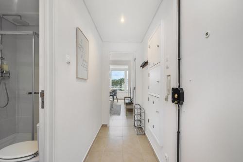 a white hallway with a toilet and a sink at WHome Peaceful Algés Family Home away from City Noise in Lisbon