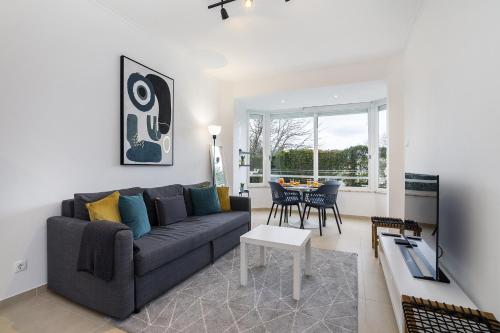 a living room with a couch and a table at WHome Peaceful Algés Family Home away from City Noise in Lisbon