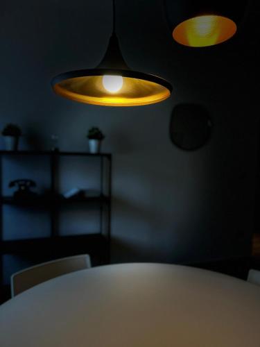a dining room with a table and a yellow light at CASA GAH in Ripatransone