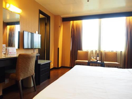 En eller flere senger på et rom på Best Western Plus Hotel Kowloon