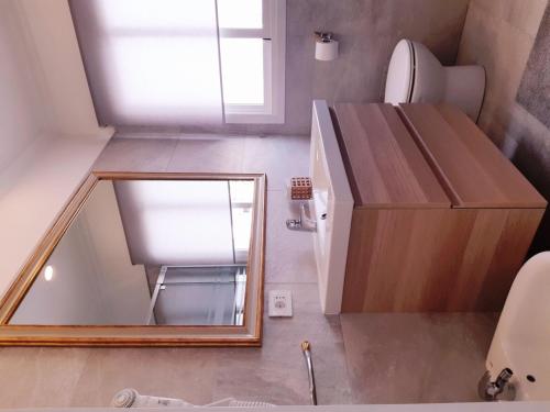 a small bathroom with a mirror next to a toilet at Heliopolis in San Agustin