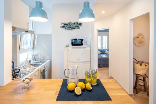 a kitchen with a table with lemons on it at Nel verde a due passi dal mare in Lido di Spina